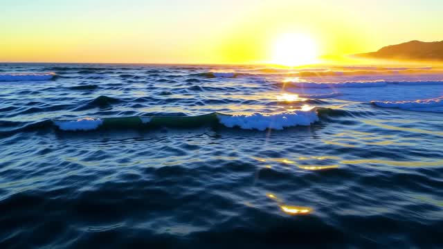 Sunrise over calm ocean waves at golden hour AI video preview