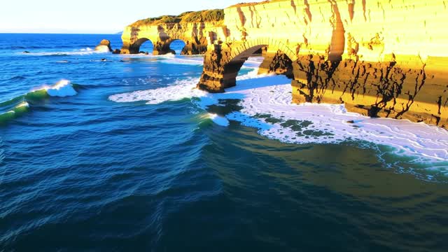 Dramatic coastal sea arches at sunset on rough ocean waves AI video preview
