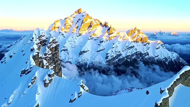 Dramatic sunrise over high snow covered mountain peaks AI video preview