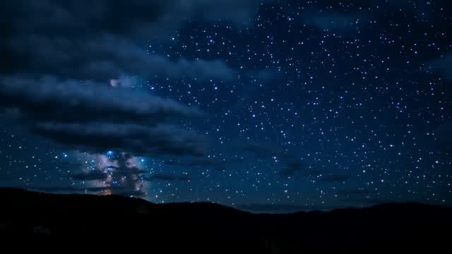Milky Way galaxy sky over mountain silhouette at night AI video preview